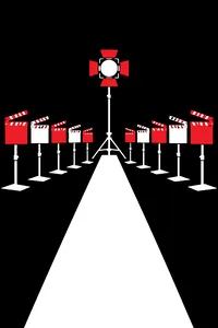 A row of ten film clapboards in a television studio, each painted a different color, with a single spotlight between them.