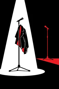 An empty microphone stand under a single spotlight with a leather jacket draped over it and a second mic stand in shadow.