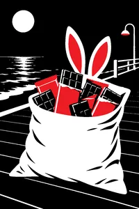 A pillowcase overflowing with full-size chocolate bars on a dark beach boardwalk, a pair of pink bunny ears on top.