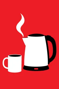 A simple electric kettle on its base with a wisp of steam at the spout and a mug waiting beside it.