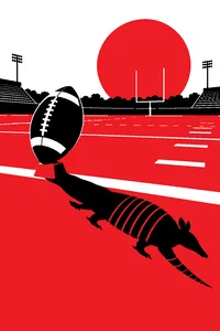 A single kicking tee holding a football on an empty college field, an armadillo-shaped shadow cast across the yard line.