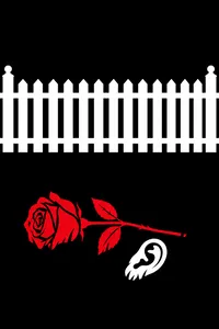 A red rose and a human ear on a lawn below a white picket fence
