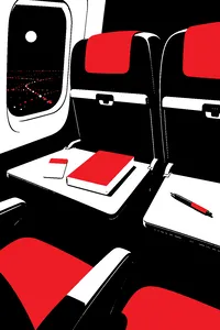 Two airplane seats at night, a hotel keycard and a paperback on one tray table, a ballpoint pen on the other.