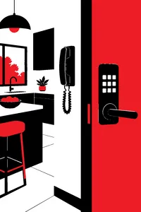 A landline phone on a wall in a modern kitchen, a smart-lock keypad glowing on the door beside it.