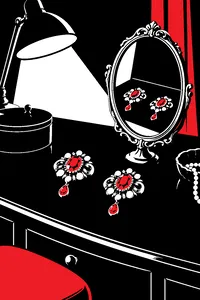 Two identical brooches on a dark vanity table, reflected in an ornate hand mirror under a single lamp.