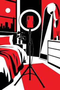 A smartphone propped on a ring light in a bedroom with a fur hat hanging from the mirror.