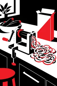 A hand-crank spiralizer clamped to a counter with a pile of green squash noodles beside an empty pasta box.