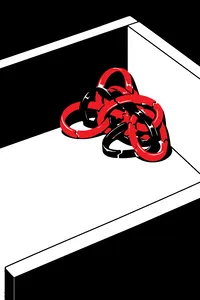 A knotted, dried-out clump of tan and red rubber bands stuck together in a drawer corner, cracked and shiny.